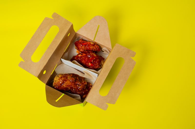 Honey garlic glazed wings served with fresh garnish at Wing Snob