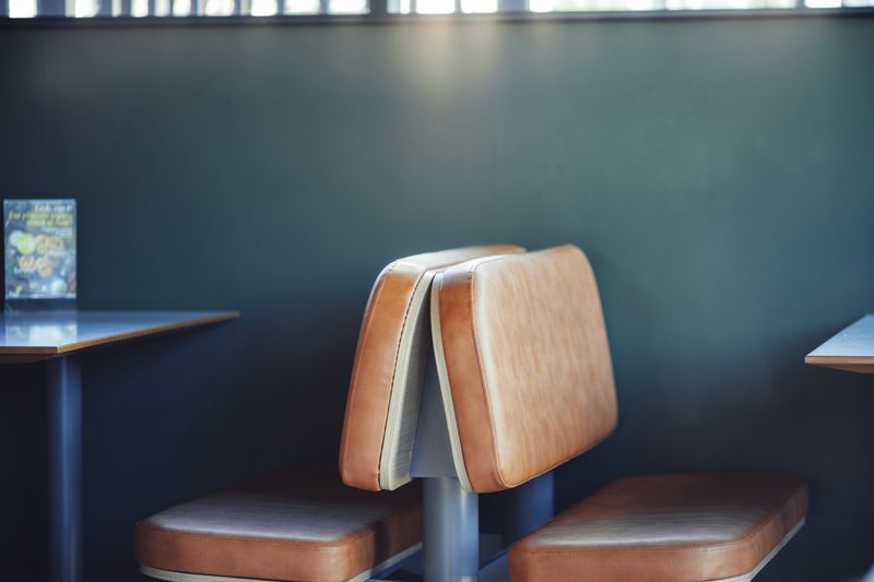 Cozy corner booth seating inside Wing Snob restaurant